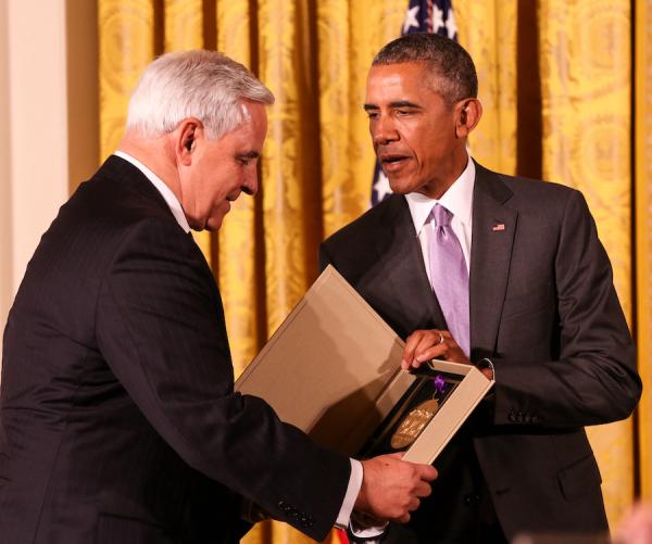 photo of Barack Obama giving a national medal to University Musical Society president Kenneth Fischer