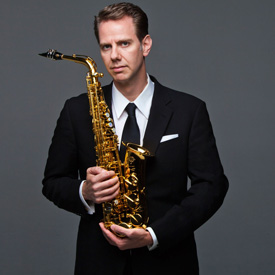 photo of Timothy McAllister holding a saxaphone