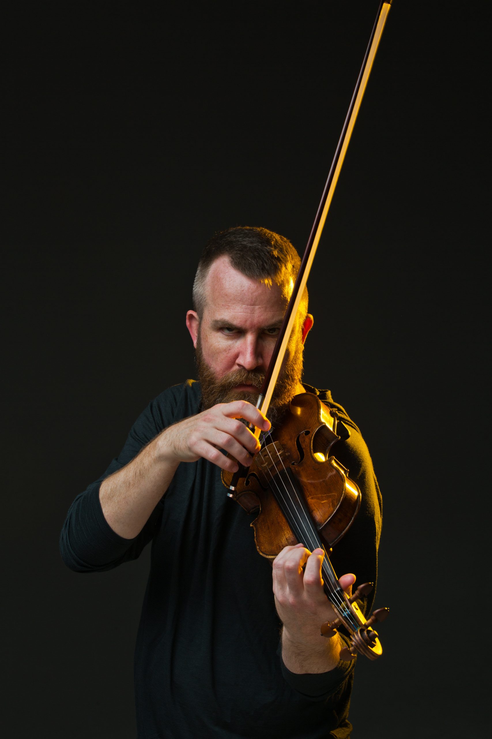 photo of Matt Albert holding a violin